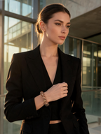 Hand wearing the Black Gold Super Seven bracelet during a seated meditation pose