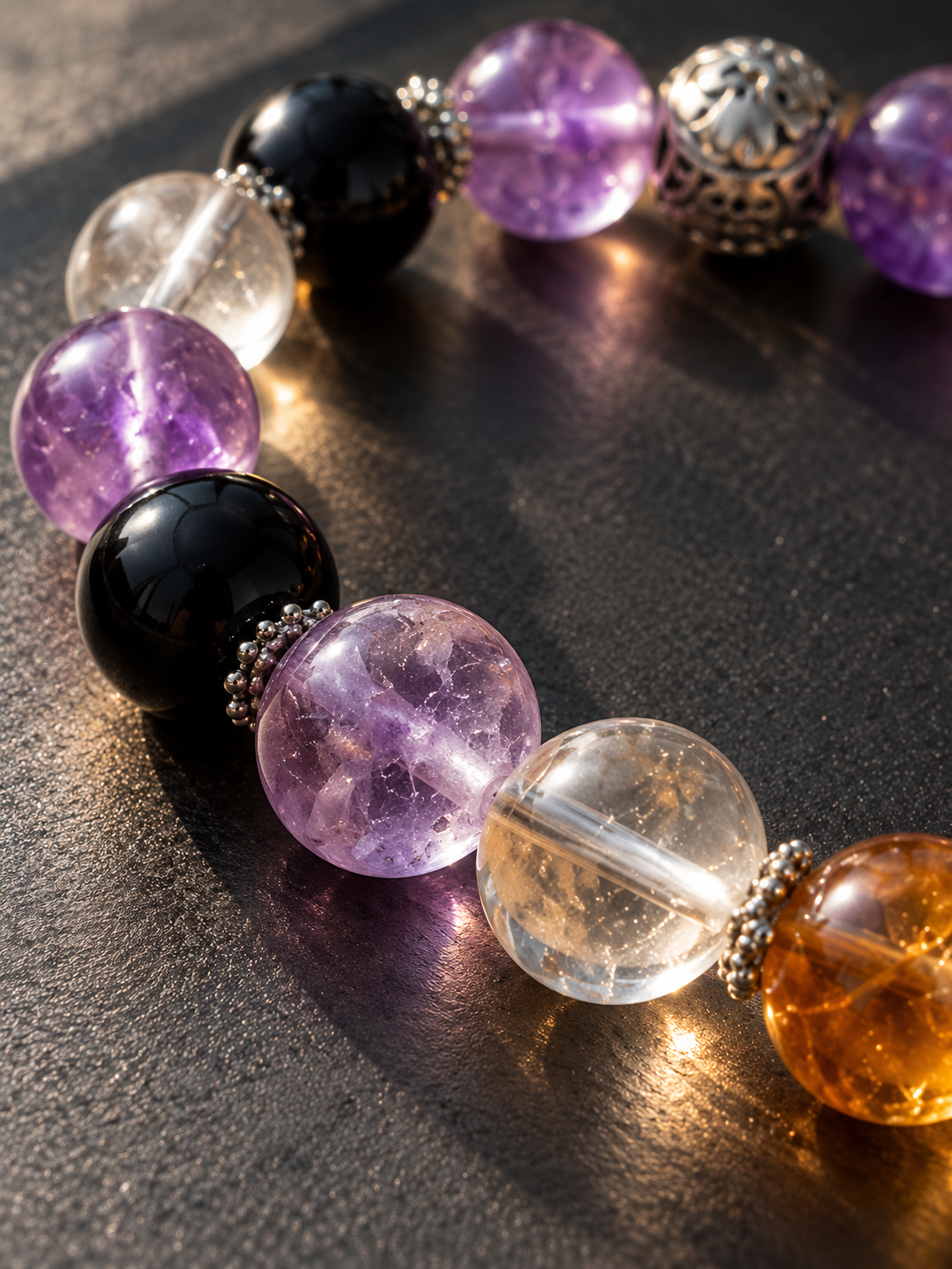 Close-up of Capricorn bracelet featuring Amethyst, Obsidian, Golden Flower Agate and Clear Quartz