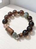 Natural Ice Obsidian bracelet with green crystal, agarwood plaque and Black Gold Super Seven beads in a 14mm design