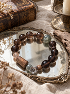 Natural Ice Obsidian bracelet with green crystal, agarwood and Black Gold Super Seven styled in a refined Chinese-inspired setting