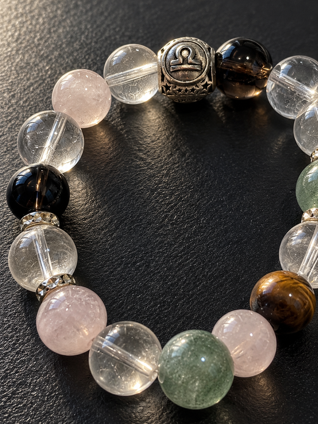 Close-up of Libra bracelet featuring Green Phantom Quartz, Pink Phantom Quartz, Smoky Quartz and Tiger’s Eye