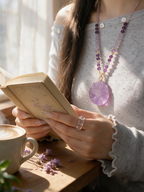 Woman wearing a natural Amethyst Fox Pendant while reading by the window, crystal jewelry for intuition, mindfulness and emotional balance.