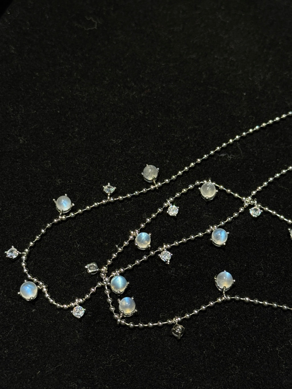 Close-up of Natural Moonstone chain necklace showing luminous gemstone drops and fine chain details
