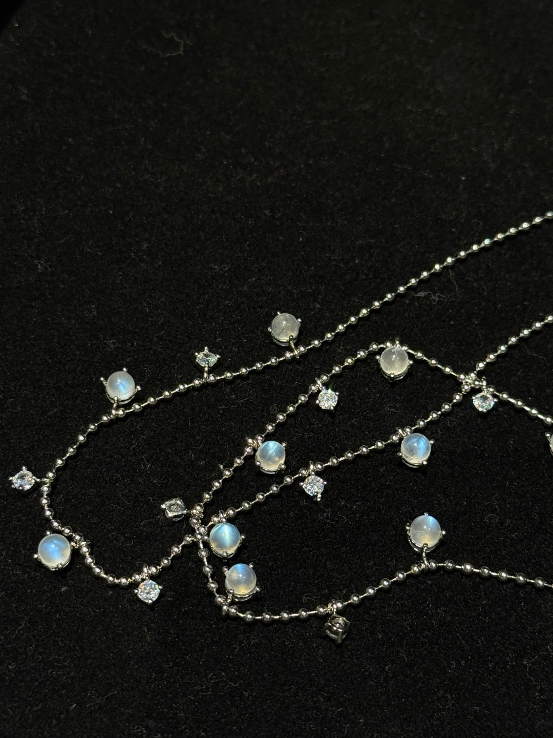 Close-up of Natural Moonstone chain necklace showing luminous gemstone drops and fine chain details