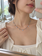 Natural Moonstone chain necklace worn around the neck with a delicate minimalist styling