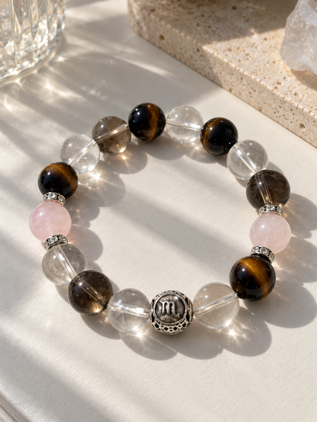 Scorpio zodiac bracelet with Clear Quartz, Smoky Quartz, Pink Phantom Quartz, Tiger’s Eye and zodiac spacer