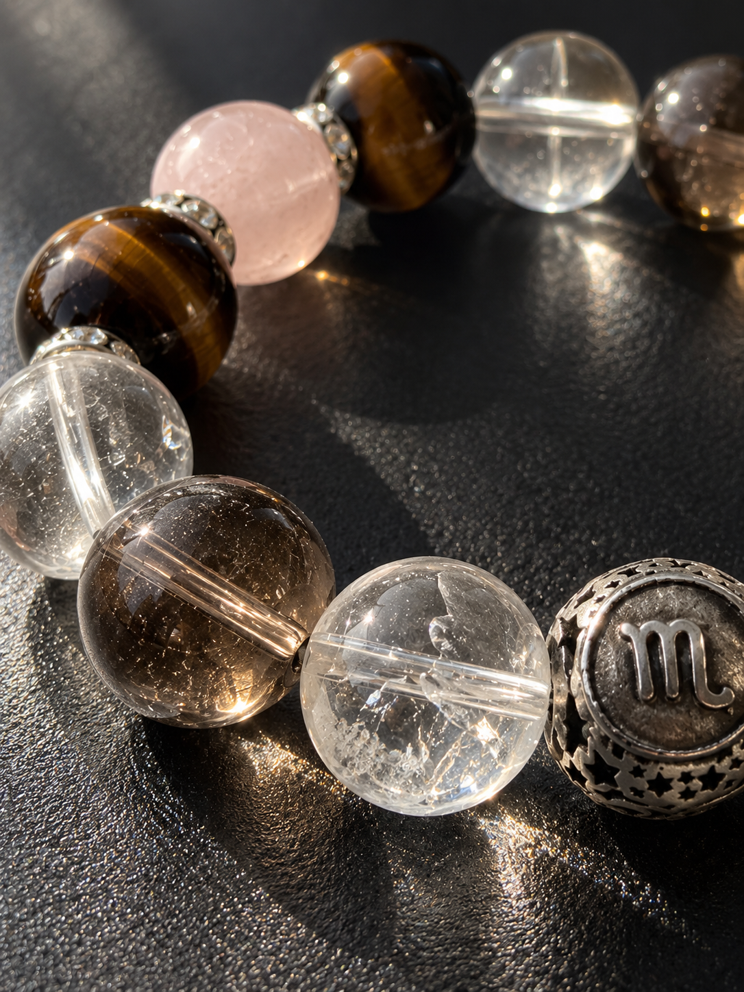 Close-up of Scorpio bracelet featuring Smoky Quartz, Pink Phantom Quartz, Tiger’s Eye and Clear Quartz